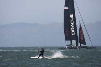 America's Cup AC45 catamaran and kiteboarder in San Francisco Bay. Photo copyright 2011 Gilles Martin-Raget americascup.com