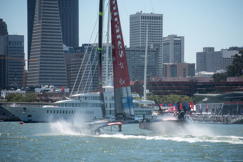 ETNZ heading at the finish line, and one of Larry Ellison's motor yachts, too.  Photo:2013 Chris Cameron/ETNZ